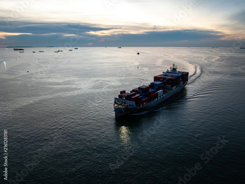 Quadro su tela Large Container Cargo Ship Sailing Through The Calm Sea During Sunset In Si Rach