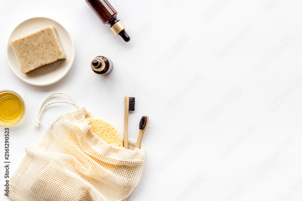 Fototapeta premium Self-care with herbal formulations - essential oils and soap - on white background top view copy space