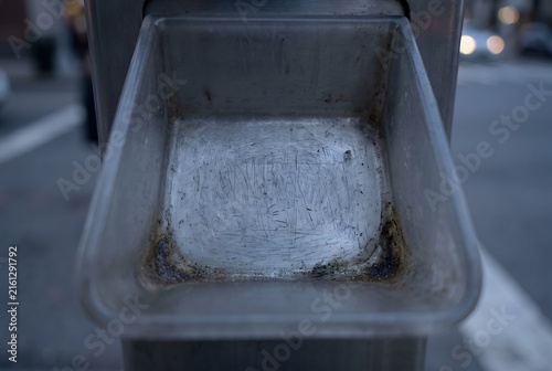 Macro close up of a vending machine coin return plastic pocket with friction scuff marks