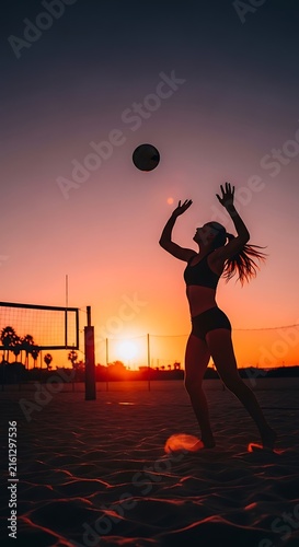 Silhouette of woman playing beach volleyball at sunset