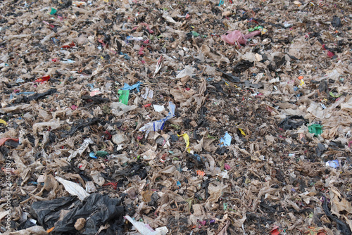 Obraz na płótnie A waste processing facility with a large pile of shredded plastic and mixed municipal waste, representing material prepared for sorting, recycling, or refuse-derived fuel production