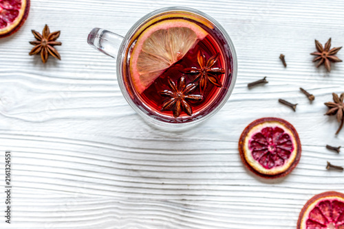 Canvastavla mulled wine with spices in cup wooden background top view