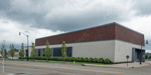 Tan Brick Commercial Building with Stormy Clouds