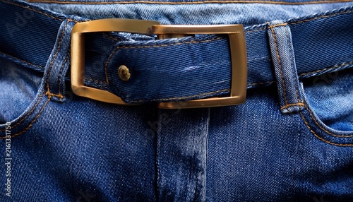closeup of the waistband and belt loop of dark blue denim jeans