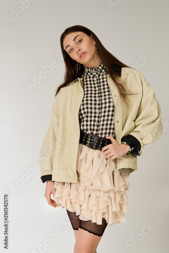 Canvastavla Stylish young woman radiates charm in cozy layered outfit.
