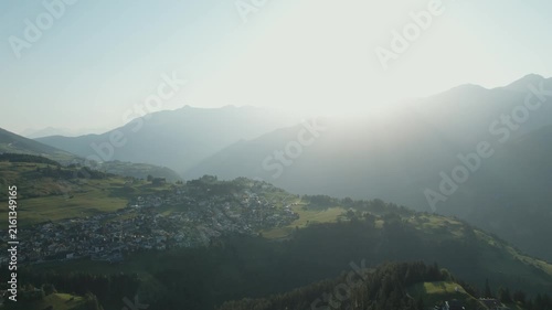 Peaceful aerial perspective of untouched mountain nature with lush forests and warm summer light.