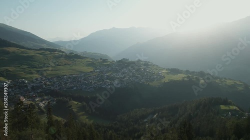 High-quality drone video featuring rolling mountain terrain, dense forests, and bright summer sunlight.