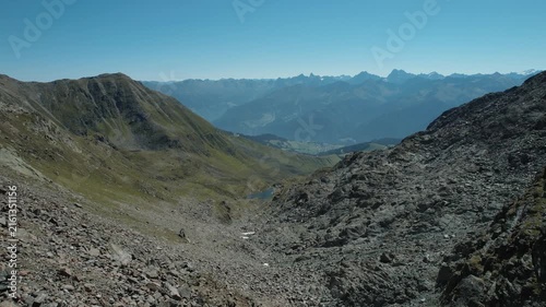 Cinematic drone footage showcasing a peaceful mountain landscape with clear weather.