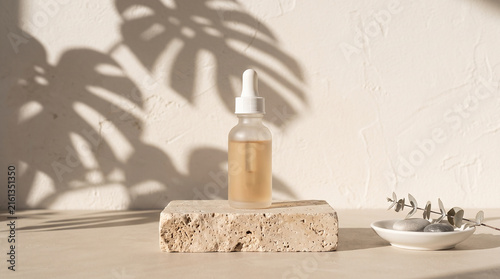 Minimalist Frosted Glass Cosmetic Dropper Bottle Mockup on Beige Travertine Stone Pedestal with Palm Leaf Shadows for Skincare Presentation
