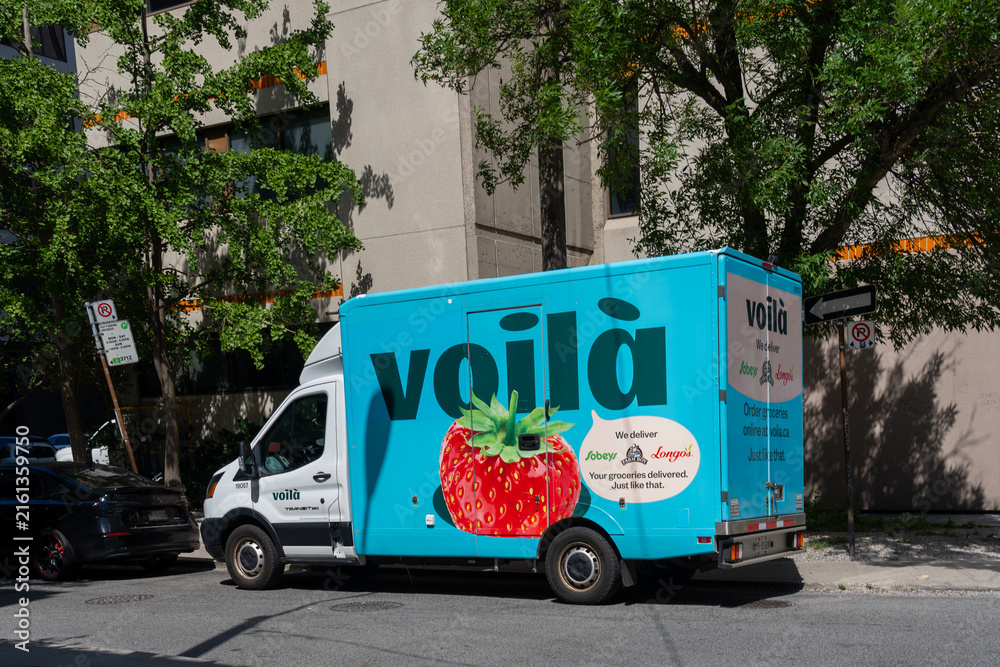 Fototapeta premium Toronto, ON, Canada - August 17, 2026: A Voila grocery delivery truck on the street in Toronto, ON, Canada. Voila is an online home grocery delivery service. 