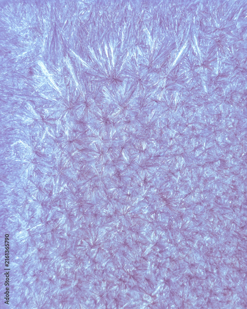 Pale lavender and blue vertical abstract macro texture with star-like crystalline growth