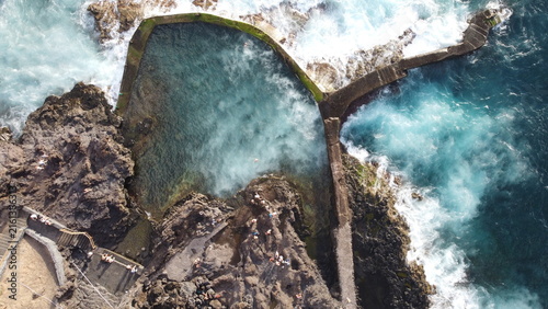 Scenic view of crystal clear ocean water in natural volcanic swimming pool at Los Gigantes, Tenerife, Spain
