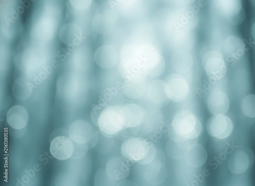 Abstract soft blue background with bright glowing circles and light bokeh effect for a calm artistic design