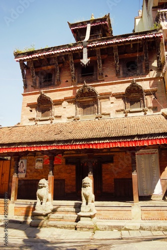 Traditional Newari building with guardian lion statues in the historic city of Bhaktapur, Nepal