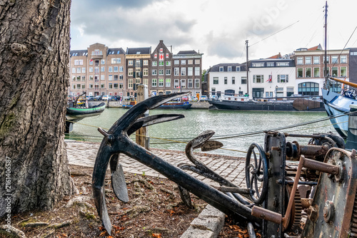 Photo of the historic harbor of Dordrecht, recognizable by nautical attributes such as these old anchors and the characteristic buildings along the quay