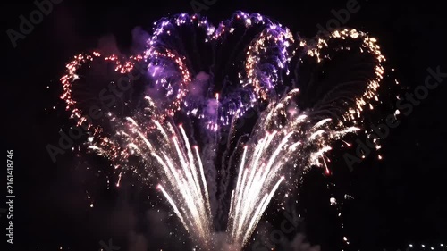 Bright Nighttime Fireworks Display Over Dark Sky with Tall White Spark Columns and Smoke Trails