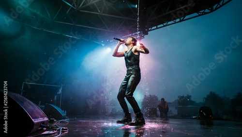 Dynamic Performance of a Solo Singer Under Rainy Stage Lights