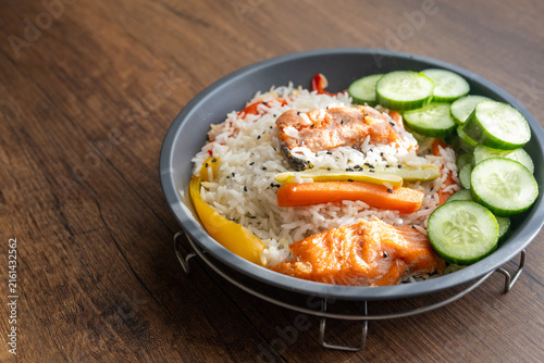 Close-up of a healthy salmon fillet served with rice and steamed vegetables
