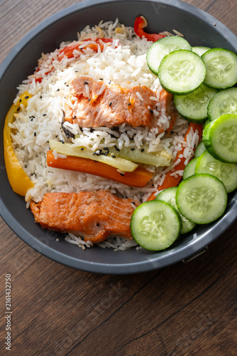 Close-up of a healthy salmon fillet served with rice and steamed vegetables