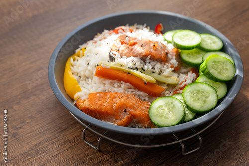 Close-up of a healthy salmon fillet served with rice and steamed vegetables