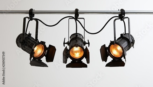 Three Black Stage Lights Mounted on a Track.