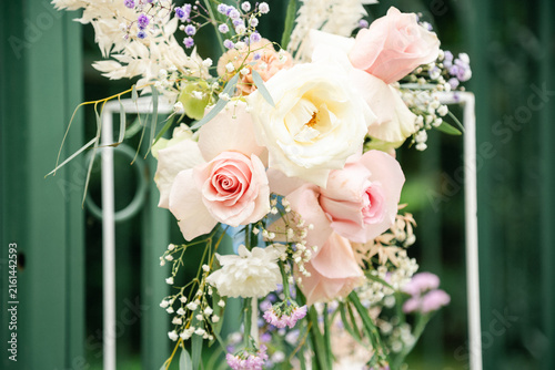 Beautiful Floral Decoration at an Outdoor Wedding Ceremony, Elegant Wedding Flowers and Arch Setup in Natural Sunlight