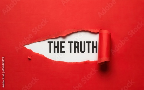 The truth text revealed behind torn red paper