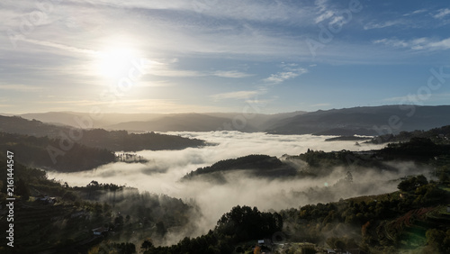 Konstfotografi Aerial view of morning cloud inversion and fog over mountain valley at sunrise