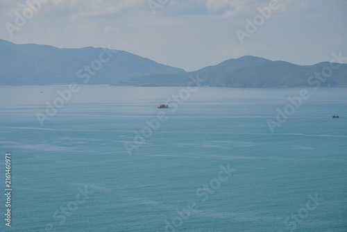 NHA TRANG, VIETNAM – MAY 10, 2026: Turquoise waters of the South China Sea with distant mountains along the northern coast of Nha Trang.
