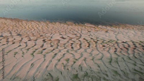 Aerial view of abstract sand patterns and flowing Danube River during low river levels	and drought
