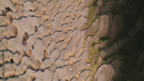 Aerial view of abstract sand patterns and flowing Danube River during low river levels	and drought
