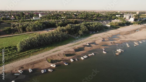 Aerial view of the low Danube with exposed sand islands and tranded, anchored boats on the Danube during severe low-water and drought conditions, at Corabia, in southern Romania

