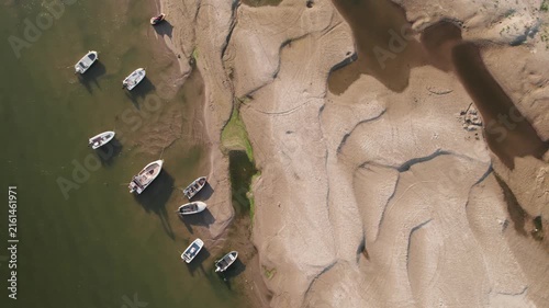 Aerial view of stranded boats on newly exposed Danube riverbank during severe low water	
