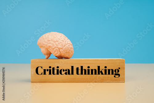 Konstfotografi Critical thinking concept with human brain model on wooden block, representing analytical thinking, problem solving, reasoning, intelligence and cognitive skills
