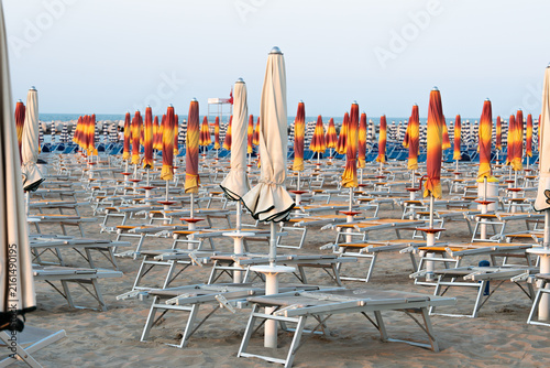 Konstfotografi Colorful Beach Umbrellas and Empty Sun Loungers by the Sea