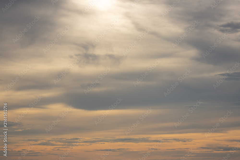 Obraz premium A dramatic sky with layers of dark clouds and a burst of bright sunlight, creating