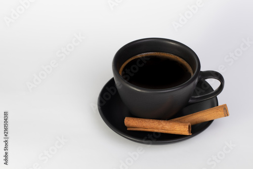 Black Coffee with Cinnamon Sticks on White Background
