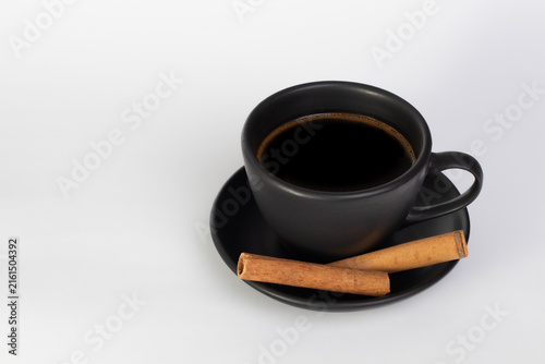 Black Coffee with Cinnamon Sticks in Minimal White Setting