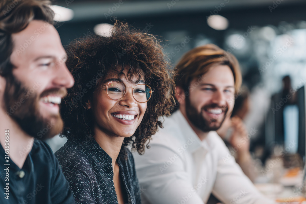 Fototapeta premium Happy businesspeople smiling and working together in the office