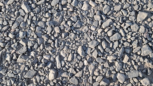 Crushed stone aggregate texture, small gray gravel background