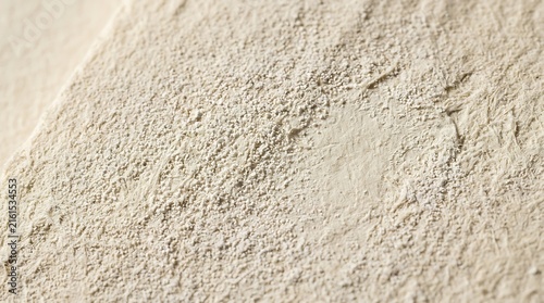 Beige chalk dust texture on matte paper surface macro background