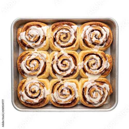Foto Freshly baked cinnamon rolls with sweet icing in a baking pan