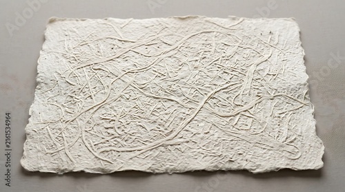 White handmade cellulose paper texture with organic fibrous surface and rough deckle edges
