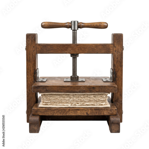Fotografie Antique wooden book press with aged paper sheets and metal screw mechanism