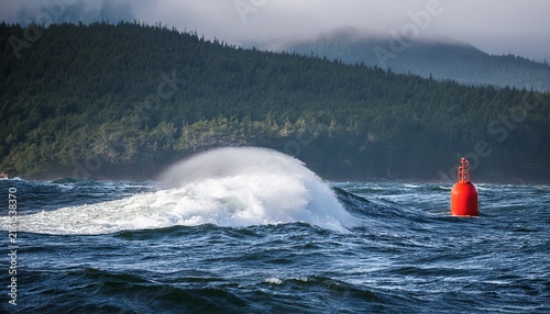 sea spray and foam swirling around a lone buoy sea spray tofino