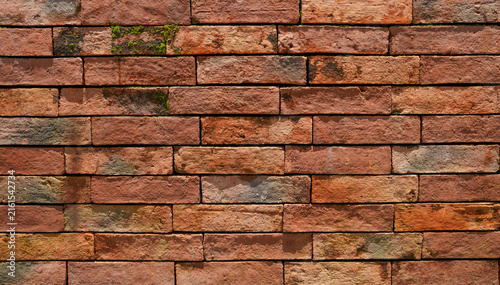 Rustic Red Brick Wall Texture with Weathered Details and Moss, Old Brickwork Background for Architectural and Design Copy Space