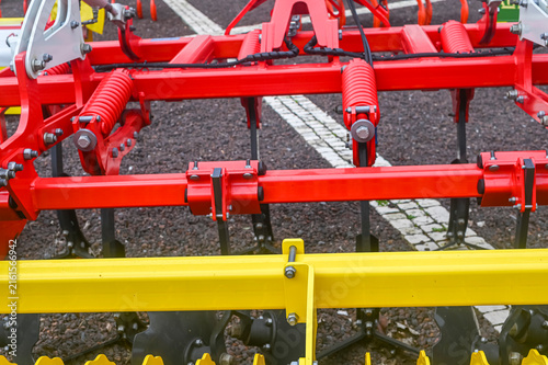 Cuadro en lienzo Red agricultural plow mechanism on gravel The Concept of farming and heavy machi