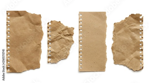 Set of brown torn notebook paper sheets with spiral holes isolated on a white background