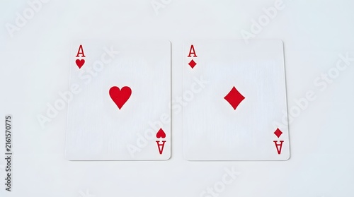 Two playing cards showing the ace of hearts and the ace of diamonds placed side by side on a flat surface for a casino or gambling game concept