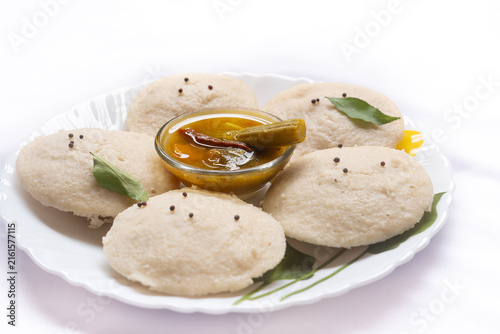 Photography Idli with Sambar, South Indian favourite food rava idli or semolina idly or rava idly, served with sambar on white plate
